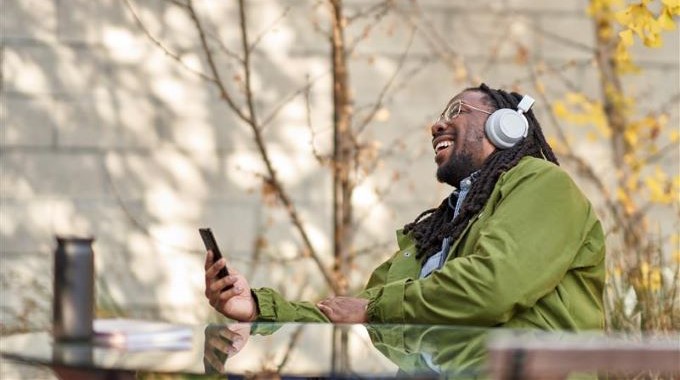 Man laughing while talking on the phone