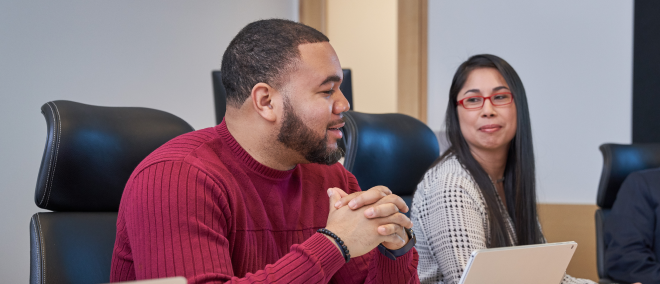 People in an office smiling.