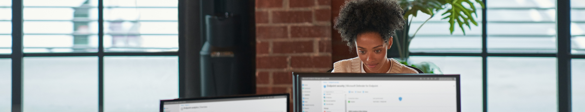 Person sitting at table typing on laptop