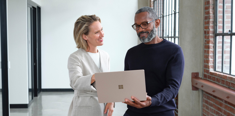 A colleague presents metrics to a client.