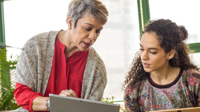 Two women looking at a Microsoft Surface tablet