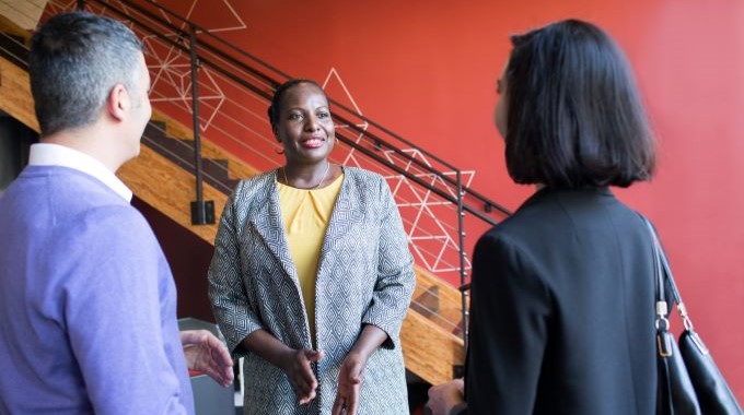 Group of people talking in a hallway