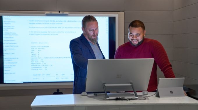 2 People looking at a computer monitor