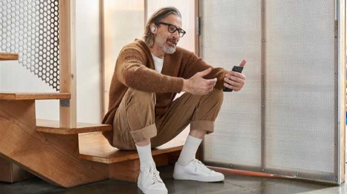 Man sitting on stairs while talking on phone